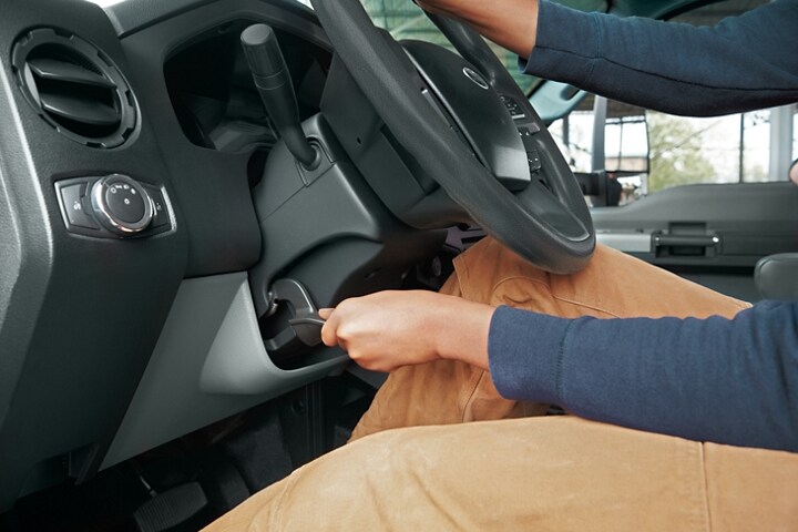 Driver adjusting tilted position of 2024 Ford F-750 steering column