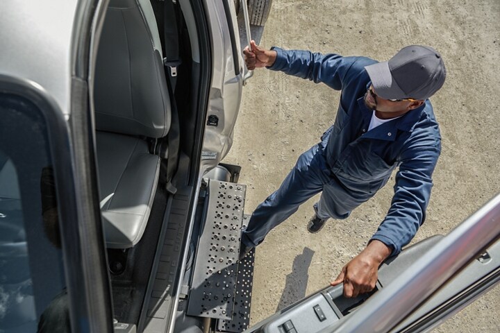 Driver entering 2024 Ford F-750 Regular Cab in Ingot Silver