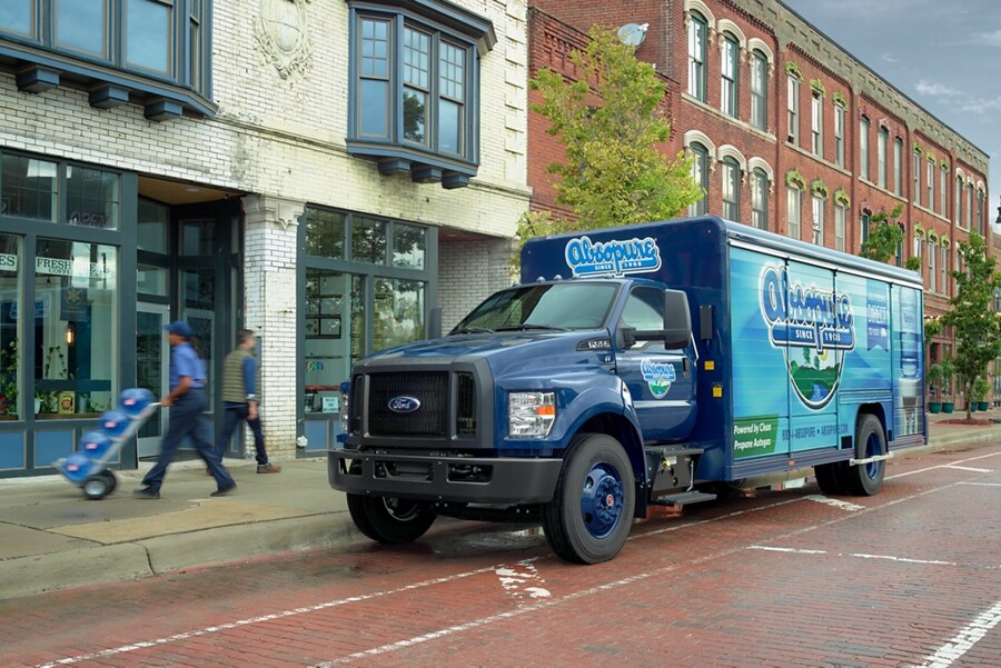 2024 Ford F-750 Regular Cab with beverage truck upfit and Absopure custom design on city street