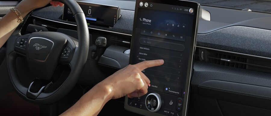 Person using the 15.5" portrait Touchscreen in a 2023 Ford Mustang Mach-E®