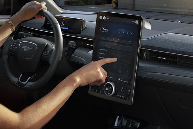 Person using the 15.5" portrait Touchscreen in a 2023 Ford Mustang Mach-E®