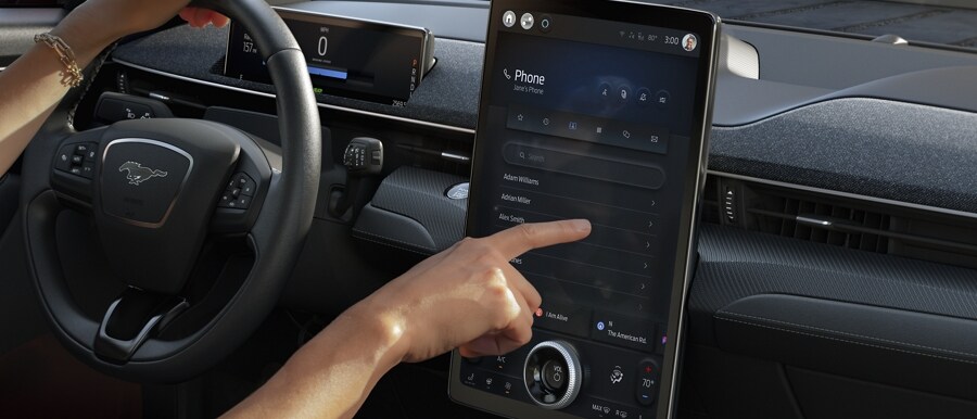 Hand shown navigating SYNC® 4A in a 2023 Ford Mustang Mach-E®