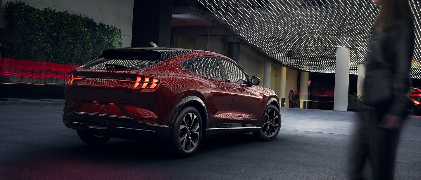 3/4 view of a 2023 Ford Mustang Mach-E® parked under ambient lights outdoors