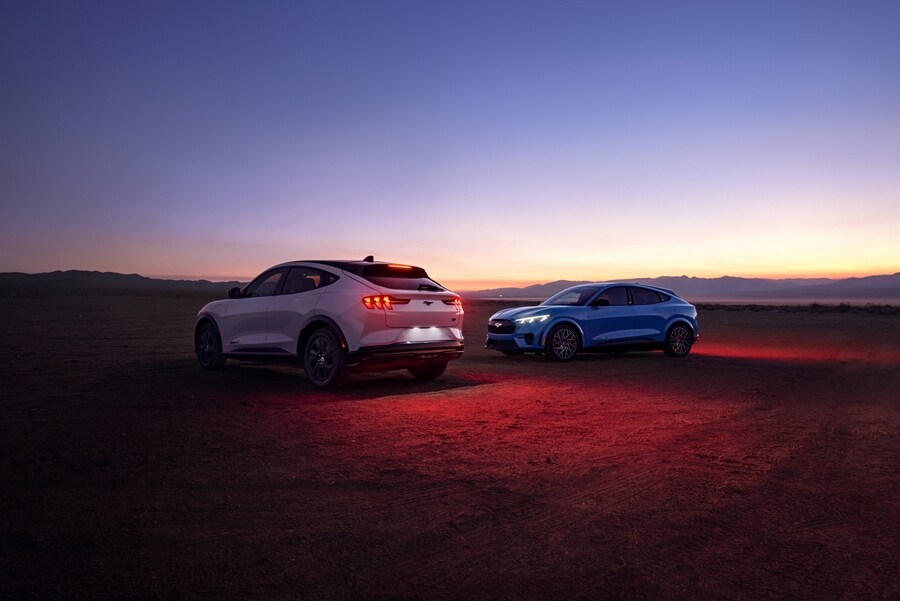 Two 2023 Ford Mustang Mach-E® SUVs parked in a desert at dusk