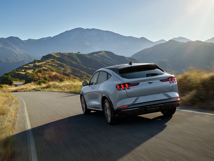 2024 Ford Mustang Mach-E® being driven with mountains visible in the foreground