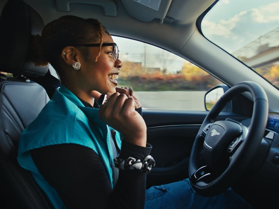A woman inside a 2024 Ford Mustang Mach-E® using Blue Cruise