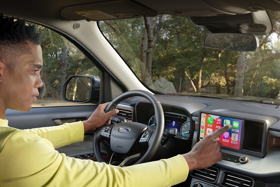 Man parked in 2023 Ford Maverick® truck using standard 8” touchscreen