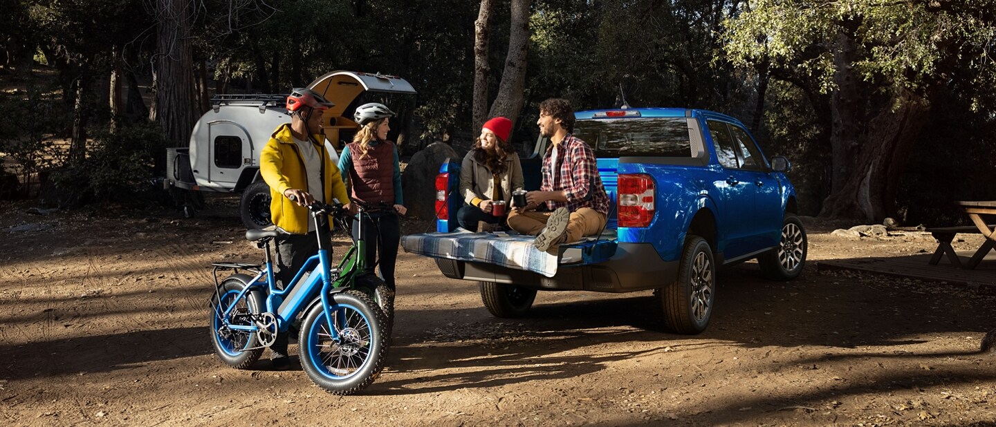 Couple sitting on tailgate of a 2023 Ford Maverick® LARIAT truck