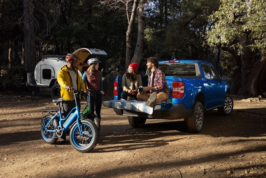 Couple sitting on tailgate of a 2023 Ford Maverick® LARIAT truck