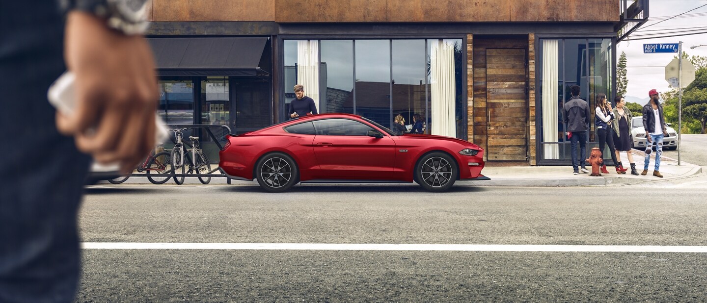 People standing near a parked 2023 Ford Mustang® coupe