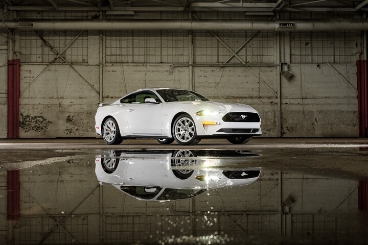 A 2023 Ford Mustang® coupe with the Mustang Ice White Appearance Package parked in a warehouse