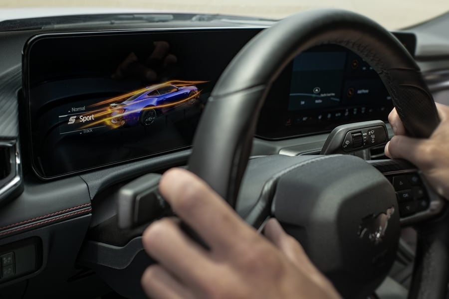Person driving a 2024 Ford Mustang® model with a view of the cockpit screens