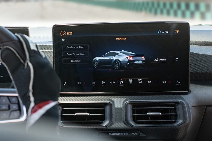 Interior view of a person driving a 2024 Ford Mustang® model on a closed course