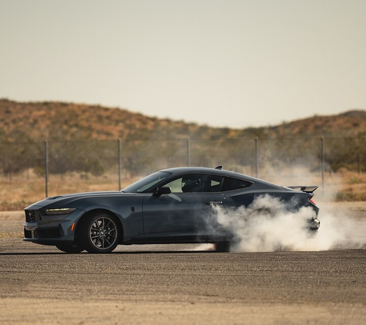 2024 Ford Mustang® Dark Horse™ model with a driver performing burnouts on a closed course