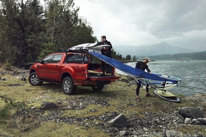2023 Ford Ranger® FX4 SuperCrew® shown in Hot Pepper Metallic being loaded with surf gear