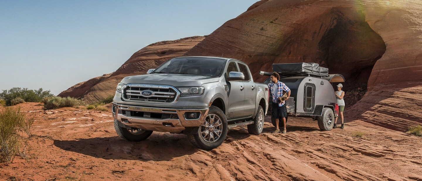 2023 Ford Ranger® parked in the desert with a couple unloading camping gear