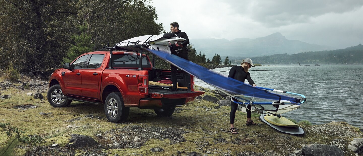 2023 Ford Ranger® in Race Red being loaded with surf gear