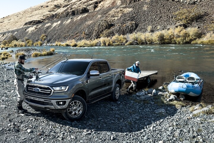 2023 Ford Ranger® parked on a river bank with men loading fishing gear
