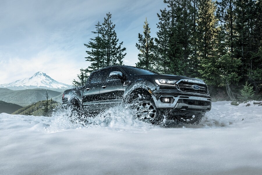 2023 Ford Ranger® shown in Carbon Black being driven through snow