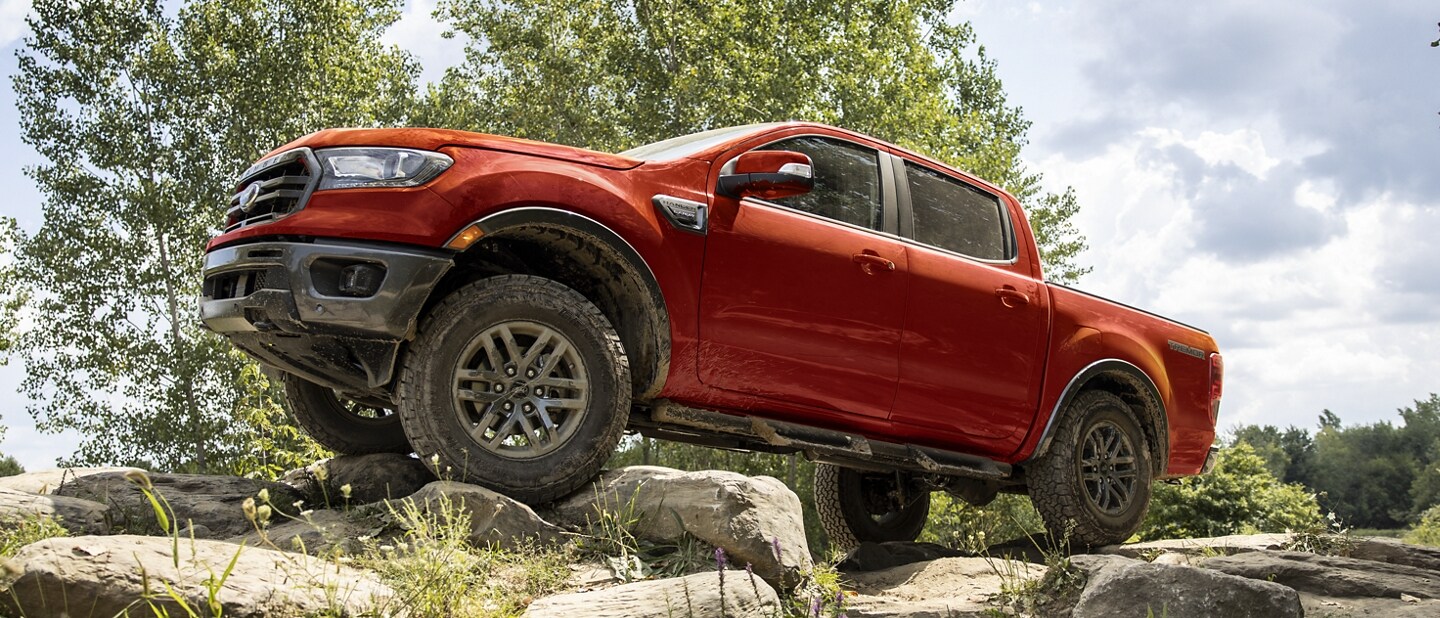 2023 Ford Ranger® shown in Race Red being driven up a rocky path