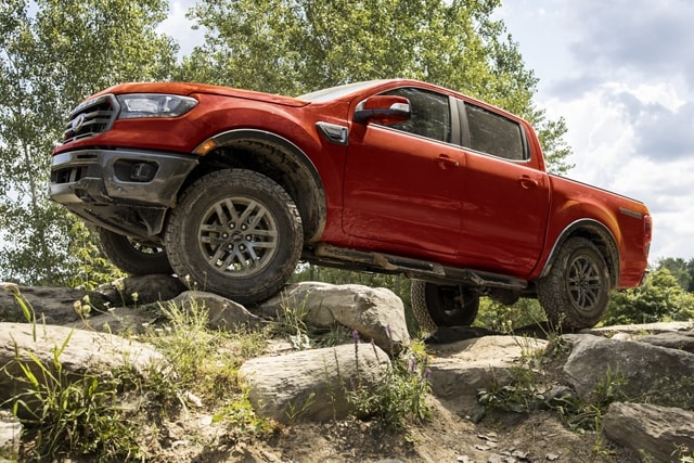 2023 Ford Ranger® in Race Red with Tremor® Off-Road Package being driven on a rocky path
