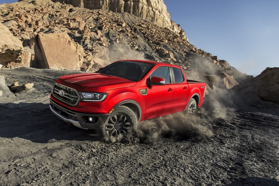 2023 Ford Ranger® in Race Red being driven up a rocky hill