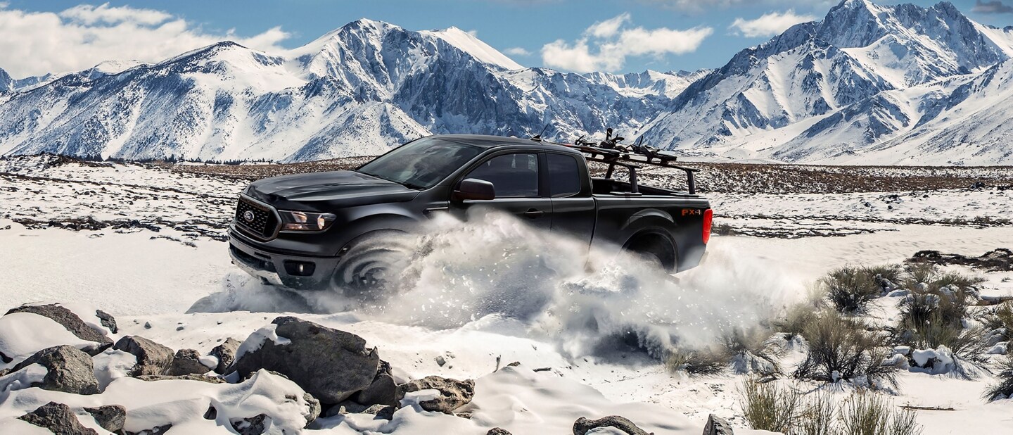 2023 Ford Ranger® in Shadow Black being driven in the snow with mountains in the background