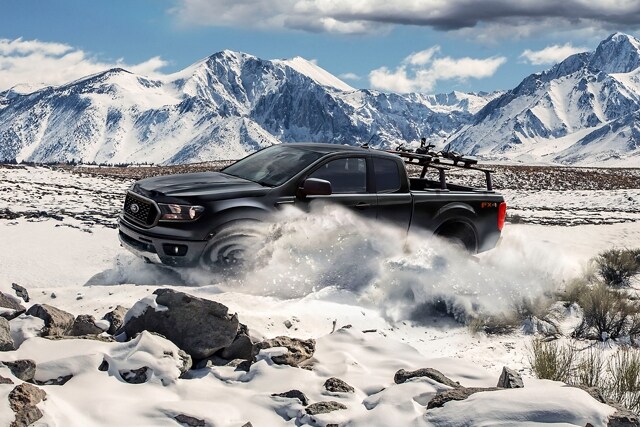 2023 Ford Ranger® in Shadow Black being driven in the snow with mountains in the background