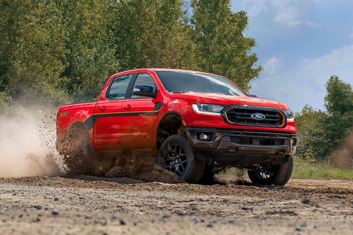 2023 Ford Ranger® SuperCrew® in Race Red kicking up dirt on a trail