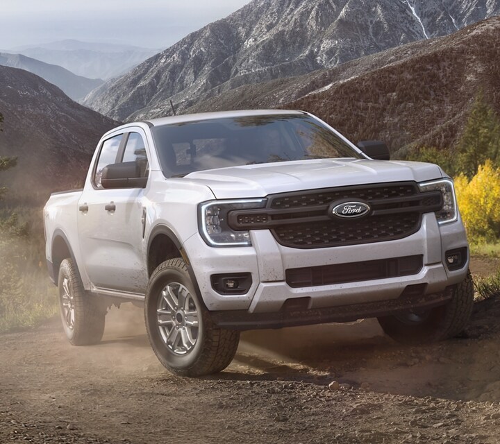 A 2024 Ford Ranger® being driven on a dirt road in a scenic location