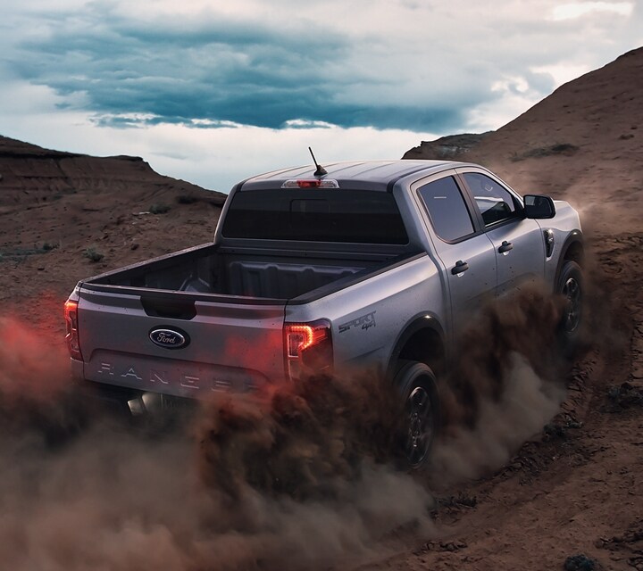 A 2024 Ford Ranger® is being driven up a sandy dune