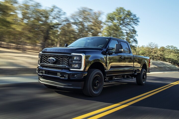 2023 Ford Super Duty® truck being driven down a rocky road