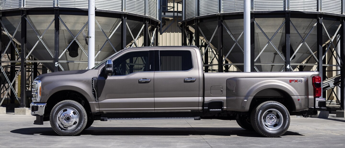 A 2023 Ford Super Duty® F-350 Lariat parked near a grain silo