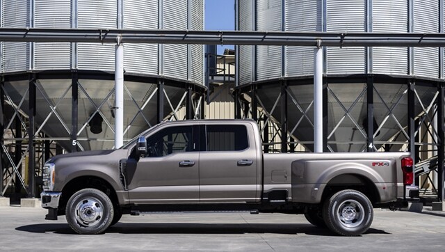 A 2023 Ford Super Duty® F-350 Lariat parked near a grain silo