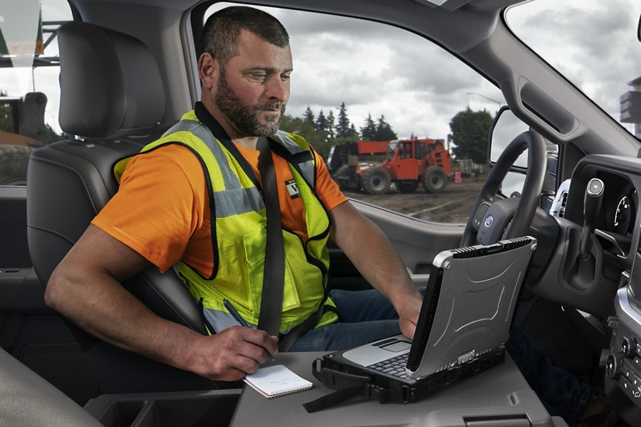 Man using a laptop computer on the Interior Work Surface feature