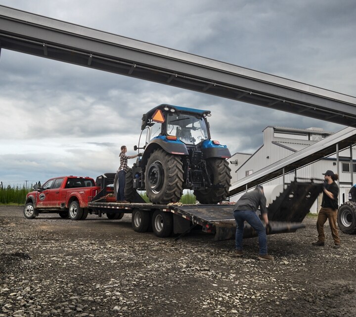 2025 Ford Super Duty® F-450® XL hitched to a trailer with a large tractor