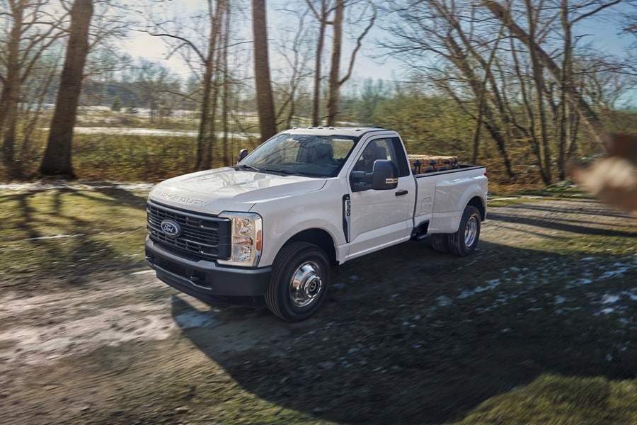 2025 Ford Super Duty® F-350® XL DRW in Oxford White being driven on a dirt road