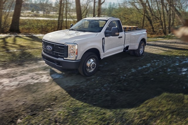 2025 Ford Super Duty® F-350® XL DRW in Oxford White being driven on a dirt road