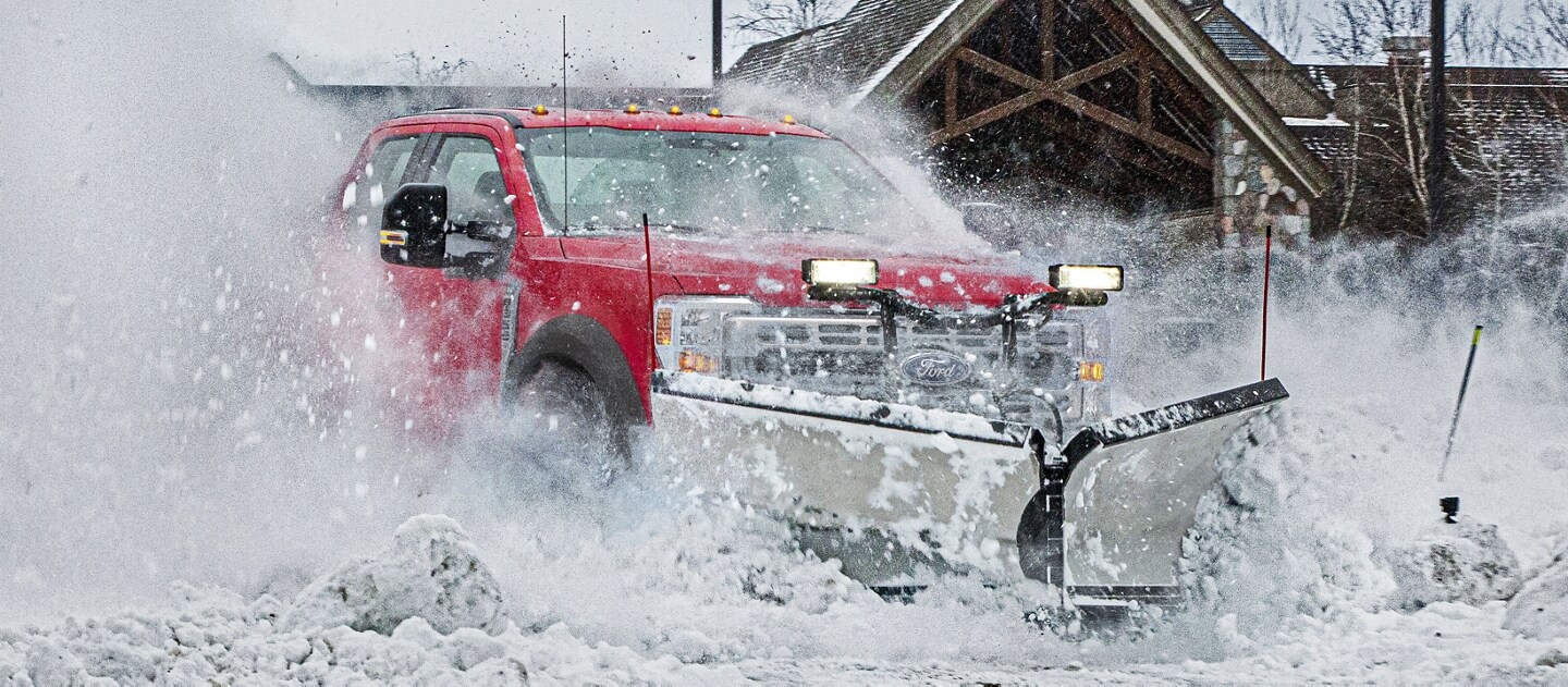 2025 Ford Super Duty® Commercial pickup with the snow plow prep package plowing through snow