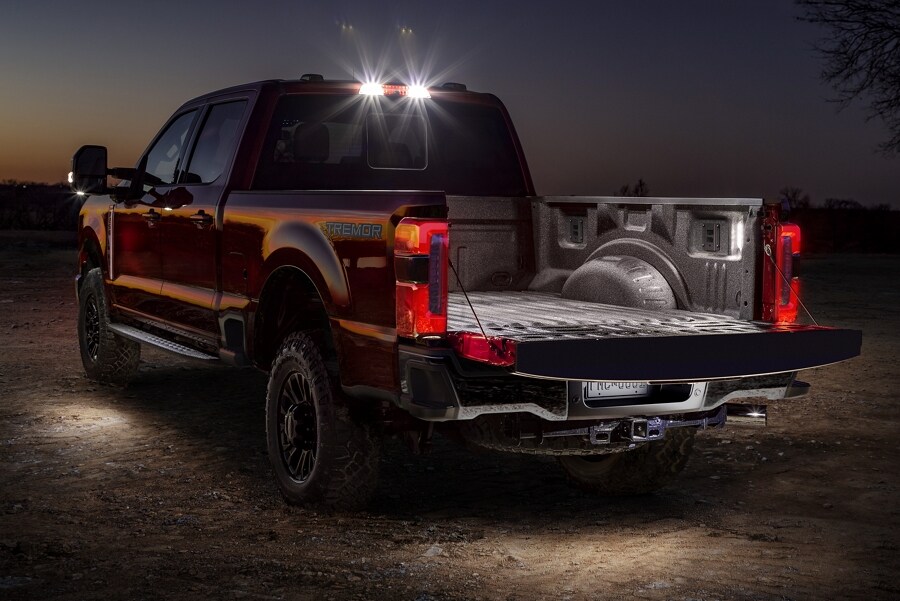 Rear view a 2025 Ford Super Duty® F-250® LARIAT® model at night with LED lights turned on