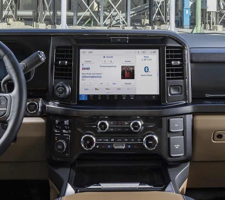 Interior highlighting the steering wheel and centre display screen of a 2025 Ford Super Duty® F-350® LARIAT® pickup