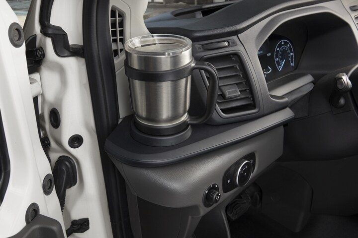 A coffee mug in the left-side cupholder