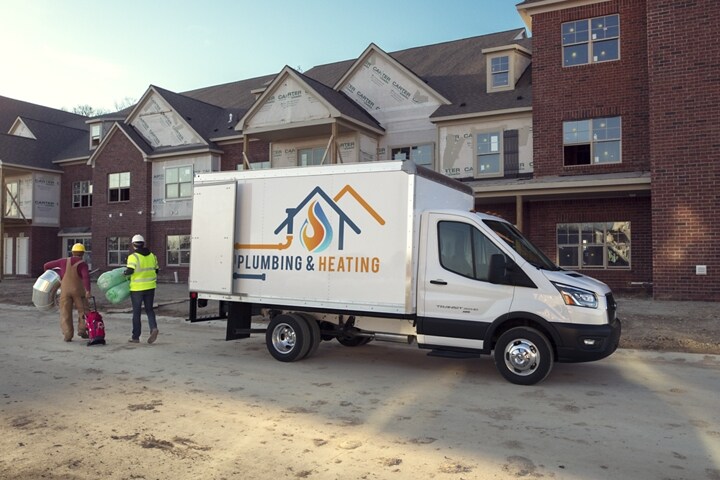 2023 Ford Transit® Chassis Cab box truck upfit on a new-build site with workers