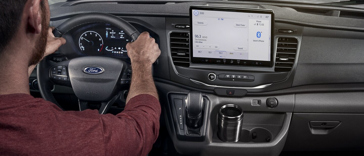 Close-up of part of the steering wheel and the centre touchscreen in a 2023 Ford Transit® Van