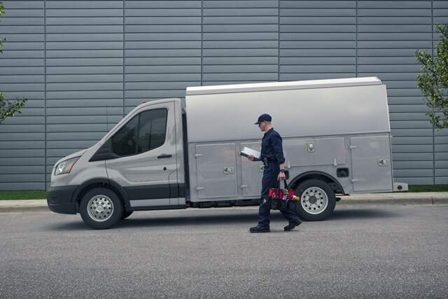 A person approaching a 2023 Transit® Chassis Cab in Avalanche Grey