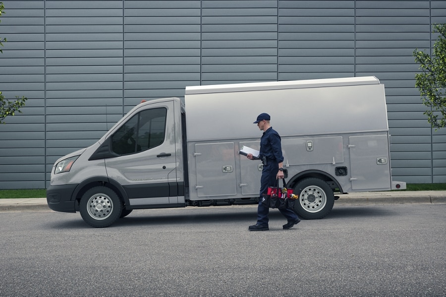 A person approaching a 2023 Transit® Chassis Cab in Avalanche Grey