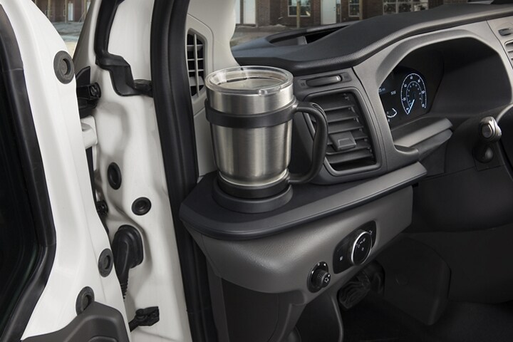 A coffee mug in the left-side cupholder