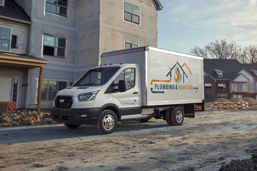 2025 Ford Transit® Chassis Cab model with box truck upfit parked at a job site