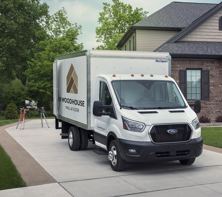 A 2025 Ford Transit® van parked in the driveway of a home with the back doors open