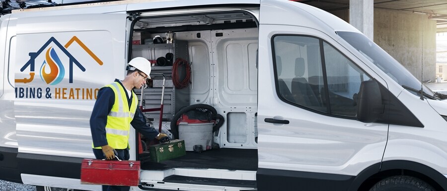 A man grabbing equipment out of the side door of a 2023 Ford Transit® Van